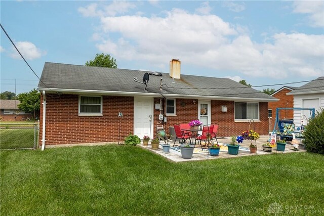 2151 Newgate Ave, Dayton, OH 45420 - back of property with a patio area, brick siding, and a chimney