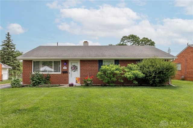 2151 Newgate Ave, Dayton, OH 45420 - view of front of home featuring brick siding, a front lawn, and a chimney