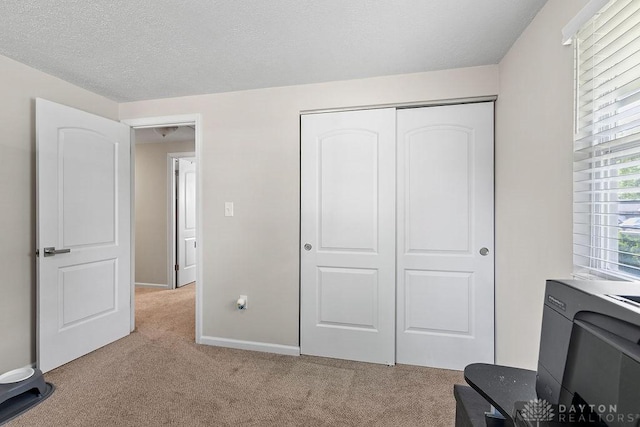 6814 Rushleigh Rd, Englewood, OH 45322 - bedroom with light colored carpet, a closet, and a textured ceiling