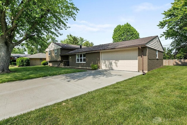 6814 Rushleigh Rd, Englewood, OH 45322 - tri-level home featuring an attached garage, concrete driveway, and brick siding