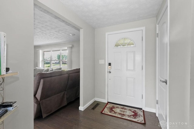 6814 Rushleigh Rd, Englewood, OH 45322 - entryway with a textured ceiling and dark wood-style floors