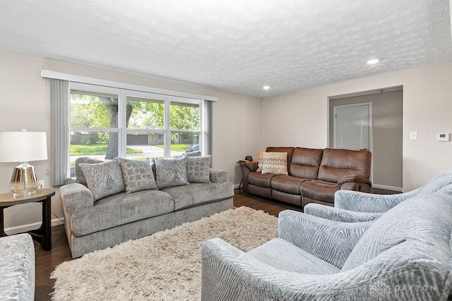 6814 Rushleigh Rd, Englewood, OH 45322 - living room featuring a textured ceiling, dark wood-style flooring, and recessed lighting
