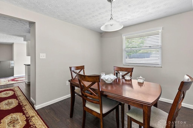 6814 Rushleigh Rd, Englewood, OH 45322 - dining room with dark wood-style flooring and a textured ceiling