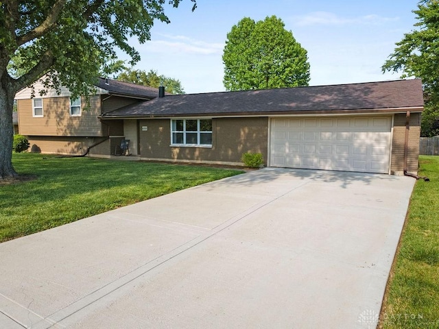 6814 Rushleigh Rd, Englewood, OH 45322 - split level home with an attached garage, concrete driveway, brick siding, and a front yard