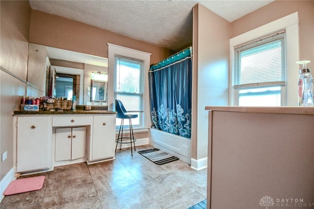 2457 Wilbraham Rd, Middletown, OH 45042 - bathroom with vanity, healthy amount of natural light, shower / tub combo, and a textured ceiling