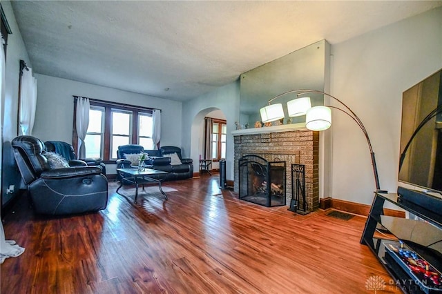 2457 Wilbraham Rd, Middletown, OH 45042 - living area with arched walkways, wood finished floors, and a brick fireplace