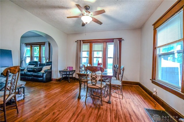 2457 Wilbraham Rd, Middletown, OH 45042 - dining room with arched walkways, wood finished floors, a textured ceiling, healthy amount of natural light, and ceiling fan