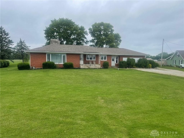 311 Swailes Rd, Troy, OH 45373 - single story home with driveway, a front yard, brick siding, and a chimney