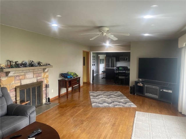 311 Swailes Rd, Troy, OH 45373 - living area with a ceiling fan, wood finished floors, a fireplace, and recessed lighting