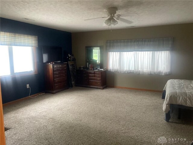 311 Swailes Rd, Troy, OH 45373 - bedroom with light carpet, a textured ceiling, and ceiling fan