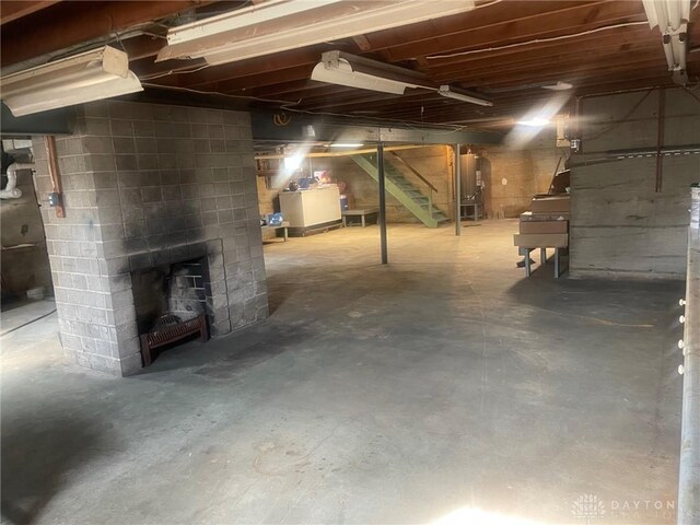 311 Swailes Rd, Troy, OH 45373 - unfinished basement with stairway, a fireplace, and washer / clothes dryer