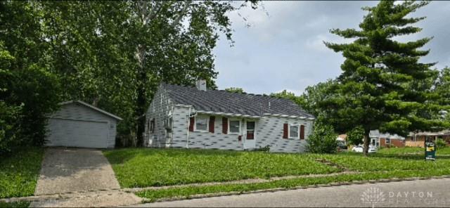 1333 Radio Rd, Dayton, OH 45403 - single story home with an outbuilding, a garage, a front lawn, and a chimney