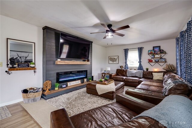 8282 Hile Ln, Germantown, OH 45327 - living area featuring wood finished floors, a ceiling fan, and a fireplace
