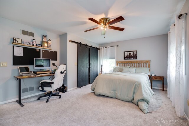 8282 Hile Ln, Germantown, OH 45327 - carpeted bedroom featuring a barn door, a desk, and ceiling fan