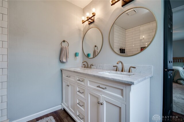 8282 Hile Ln, Germantown, OH 45327 - ensuite bathroom with double vanity and wood finished floors