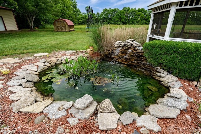 8282 Hile Ln, Germantown, OH 45327 - view of grassy yard with a garden pond, a shed, and a sunroom