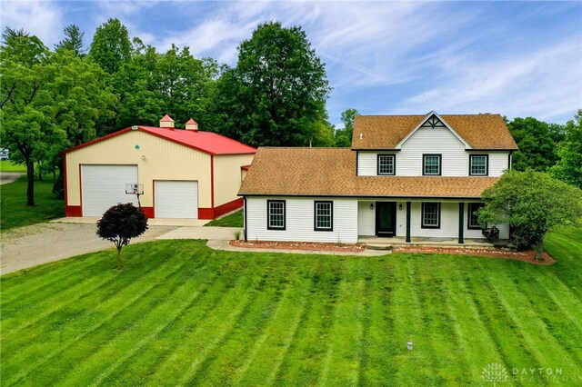 8282 Hile Ln, Germantown, OH 45327 - view of front of home with a detached garage, covered porch, a front lawn, an outbuilding, and a shingled roof