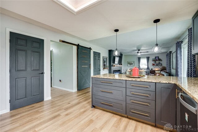 8282 Hile Ln, Germantown, OH 45327 - kitchen with a barn door, a ceiling fan, a peninsula, stainless steel dishwasher, and open floor plan
