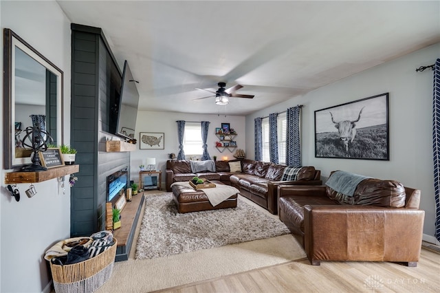8282 Hile Ln, Germantown, OH 45327 - living area featuring wood finished floors, a ceiling fan, and a fireplace