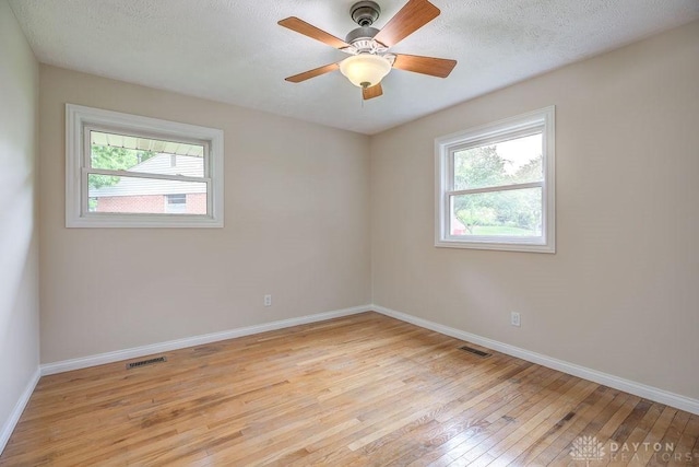 5807 Twin Pine Ln, Miami Twp, OH 45449 - empty room featuring light wood-type flooring, plenty of natural light, ceiling fan, and a textured ceiling