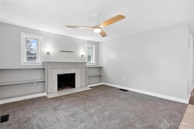 1189 Spinning Rd, Dayton, OH 45432 - unfurnished living room featuring healthy amount of natural light, a ceiling fan, a fireplace, and carpet flooring