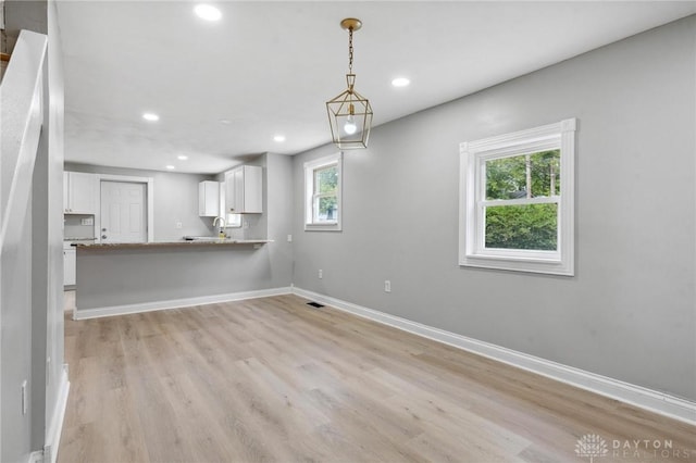 1189 Spinning Rd, Dayton, OH 45432 - unfurnished living room featuring light wood finished floors and recessed lighting