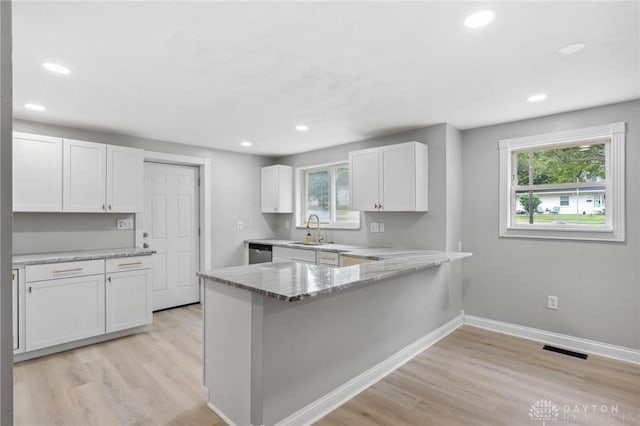 1189 Spinning Rd, Dayton, OH 45432 - kitchen featuring white cabinets, healthy amount of natural light, light wood-style floors, and recessed lighting