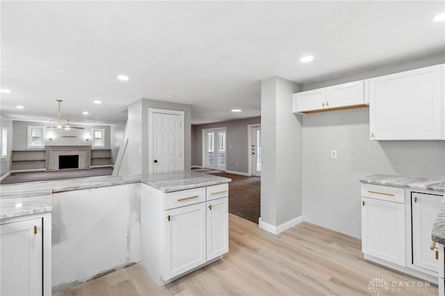 1189 Spinning Rd, Dayton, OH 45432 - kitchen featuring open floor plan, a fireplace, white cabinets, recessed lighting, and light stone countertops