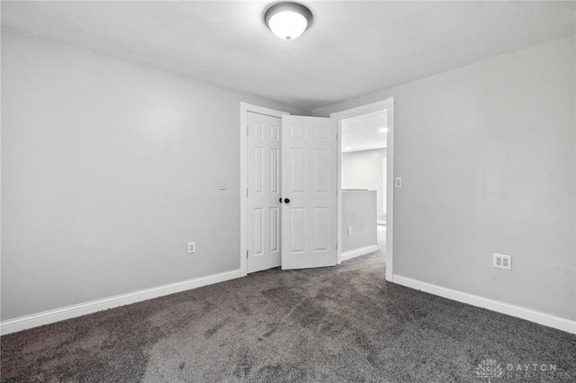 1189 Spinning Rd, Dayton, OH 45432 - unfurnished bedroom with dark colored carpet and a closet
