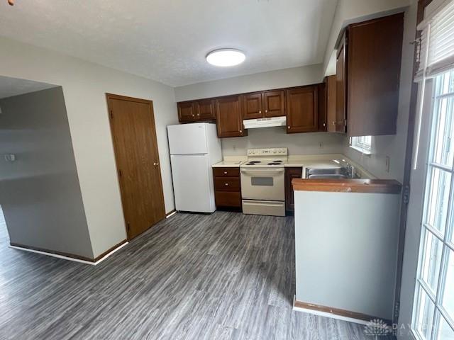 1616 Belvo Rd Unit 1610, Miamisburg, OH 45342 - kitchen with white appliances, under cabinet range hood, dark wood-style floors, and light countertops