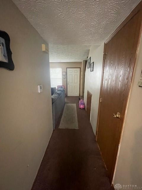 1616 Belvo Rd Unit 1610, Miamisburg, OH 45342 - hall featuring a textured ceiling and dark carpet