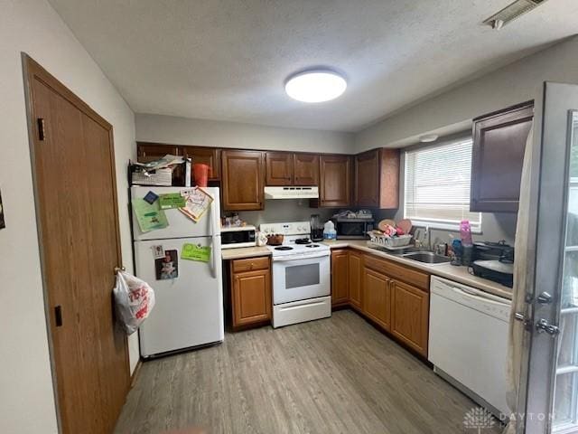 1608 Belvo Rd Unit 1602, Miamisburg, OH 45342 - kitchen featuring white appliances, under cabinet range hood, light wood finished floors, and light countertops