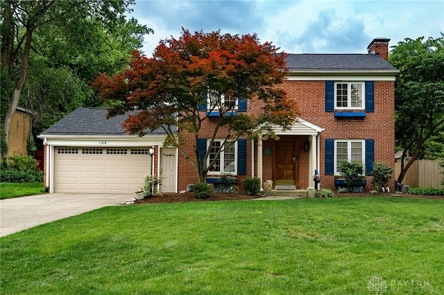 164 Winding Way, Kettering, OH 45429 - view of front of property featuring driveway, a chimney, an attached garage, and brick siding