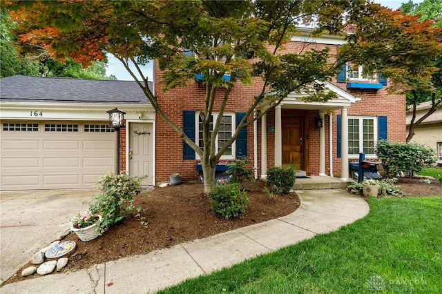 164 Winding Way, Kettering, OH 45429 - view of front facade with brick siding, concrete driveway, an attached garage, and roof with shingles