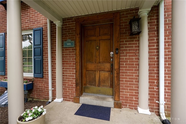 164 Winding Way, Kettering, OH 45429 - property entrance featuring brick siding and covered porch