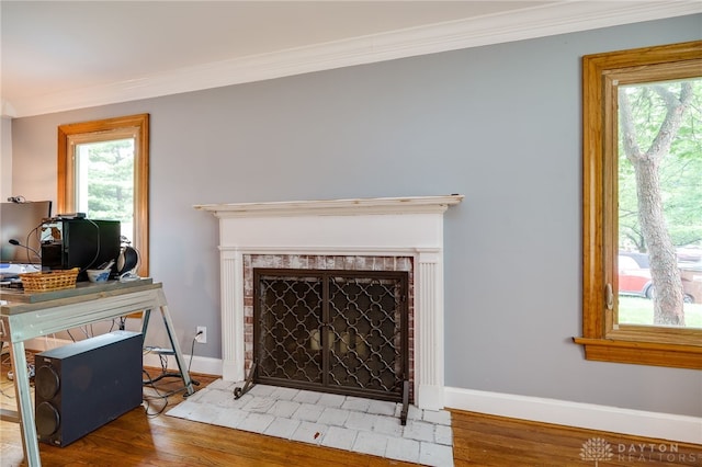 164 Winding Way, Kettering, OH 45429 - living area with crown molding, wood finished floors, a fireplace with flush hearth, and an office area