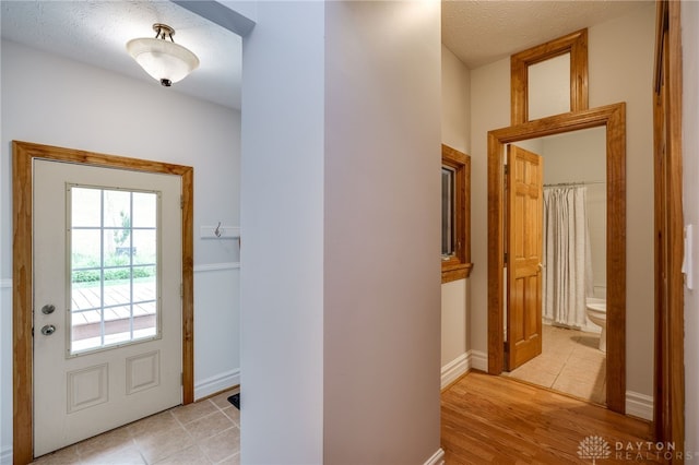 164 Winding Way, Kettering, OH 45429 - entrance foyer with a textured ceiling and light tile patterned floors