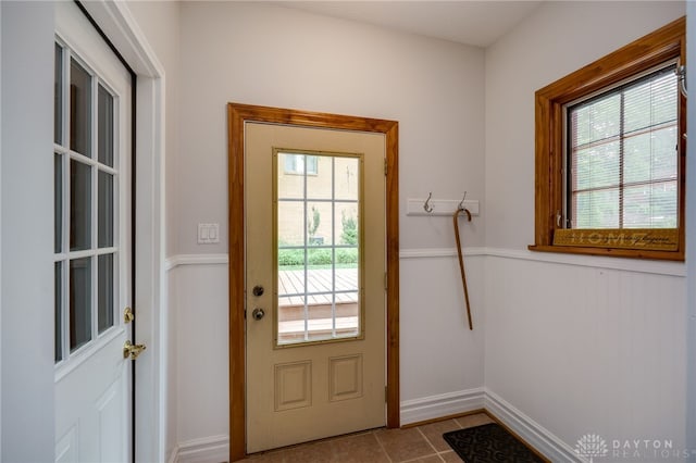 164 Winding Way, Kettering, OH 45429 - doorway featuring plenty of natural light, tile patterned floors, and wainscoting