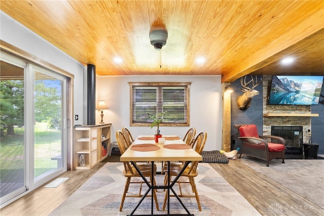 3075 Addison New Carlisle Rd, New Carlisle, OH 45344 - dining space with wood ceiling, wood finished floors, plenty of natural light, a stone fireplace, and recessed lighting