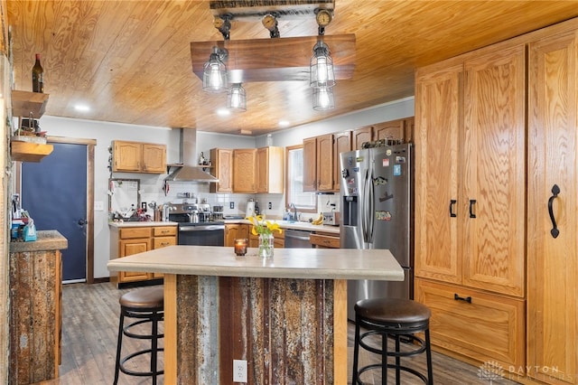3075 Addison New Carlisle Rd, New Carlisle, OH 45344 - kitchen with appliances with stainless steel finishes, wall chimney exhaust hood, wood ceiling, a breakfast bar area, and wood finished floors
