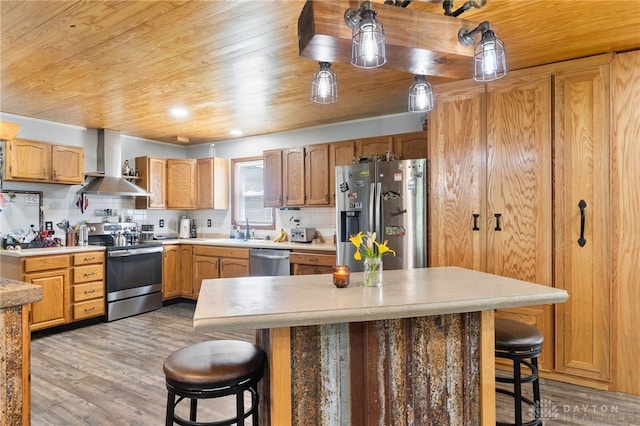 3075 Addison New Carlisle Rd, New Carlisle, OH 45344 - kitchen with stainless steel appliances, wall chimney range hood, wood ceiling, a kitchen breakfast bar, and light wood-style floors