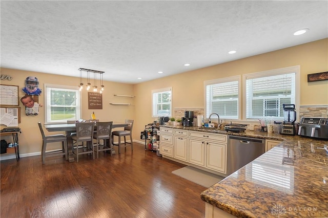855 Quarry Rd, Silver Creek Twp, OH 45335 - kitchen with stainless steel dishwasher, cream cabinets, plenty of natural light, a textured ceiling, and dark wood-style floors