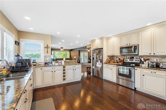 855 Quarry Rd, Silver Creek Twp, OH 45335 - kitchen with appliances with stainless steel finishes, cream cabinets, decorative backsplash, recessed lighting, and a peninsula