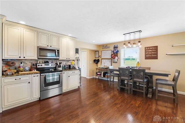 855 Quarry Rd, Silver Creek Twp, OH 45335 - kitchen with stainless steel appliances, cream cabinets, dark wood-style flooring, decorative backsplash, and recessed lighting
