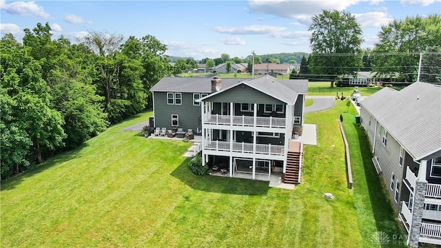 855 Quarry Rd, Silver Creek Twp, OH 45335 - rear view of house featuring stairs, a chimney, a deck, a patio area, and a yard