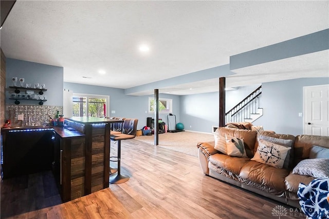 855 Quarry Rd, Silver Creek Twp, OH 45335 - living room with stairs, bar area, wood finished floors, and recessed lighting