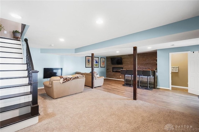 855 Quarry Rd, Silver Creek Twp, OH 45335 - carpeted living room featuring stairs, a large fireplace, recessed lighting, and wood finished floors