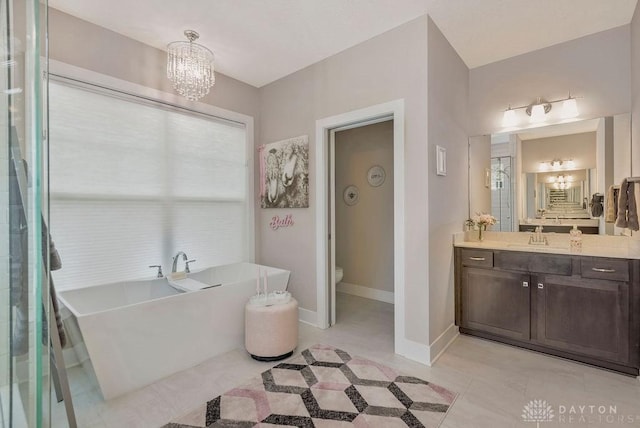 1015 Settlemyre Rd, Oregonia, OH 45054 - bathroom featuring vanity, a chandelier, a freestanding tub, and tile patterned floors