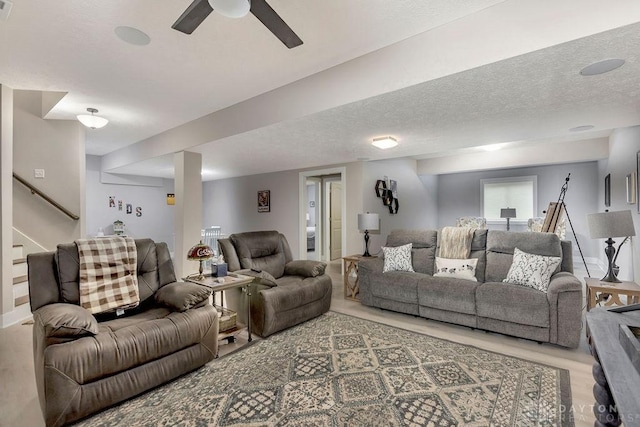 1015 Settlemyre Rd, Oregonia, OH 45054 - living area featuring ceiling fan, stairway, a textured ceiling, and wood finished floors