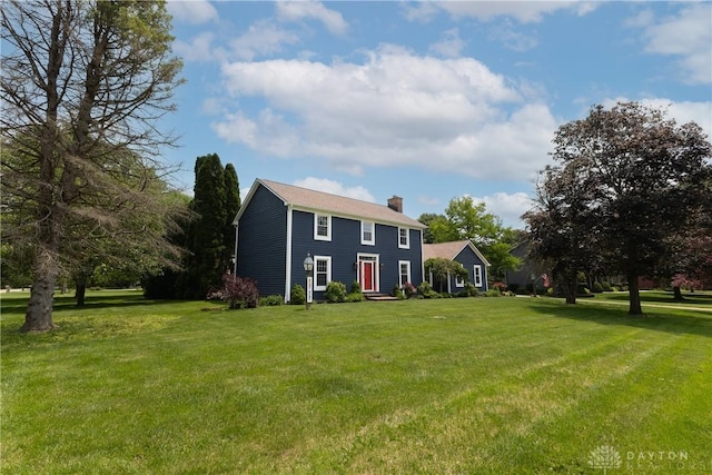 2025 Seneca Dr, Troy, OH 45373 - colonial-style house with a chimney and a front yard